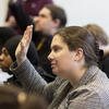 Students in class raising hands