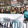 image of students walking with a walk tu banner